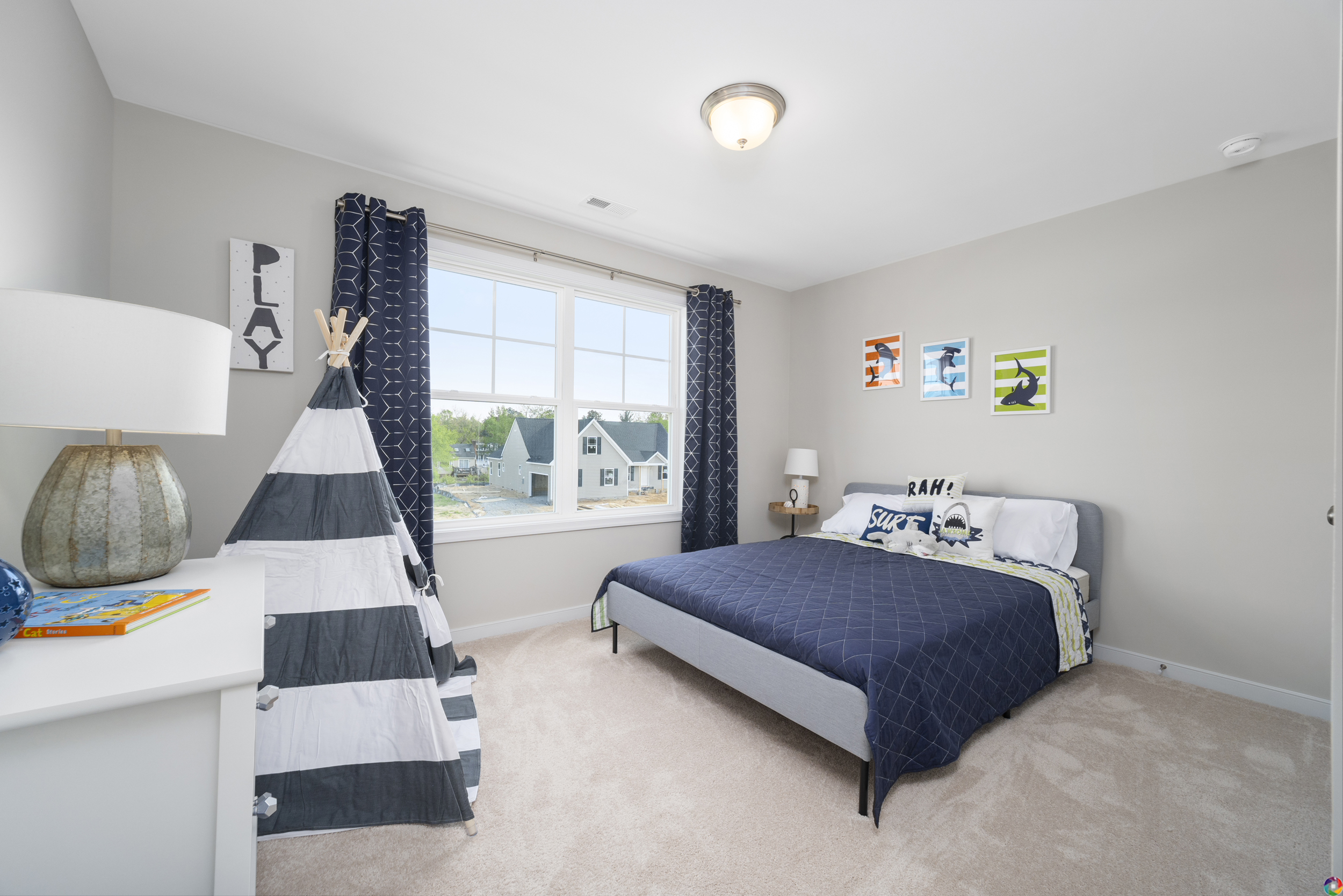 Bright, modern child's bedroom with a single bed, teepee play tent, and playful wall art, featuring a window with blue drapes.