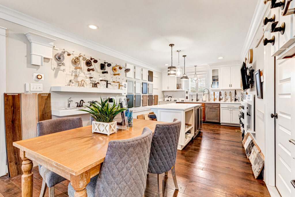 Spacious kitchen and dining area with wooden table, chairs, modern fixtures, and a Design Center for wall-mounted kitchen tools.