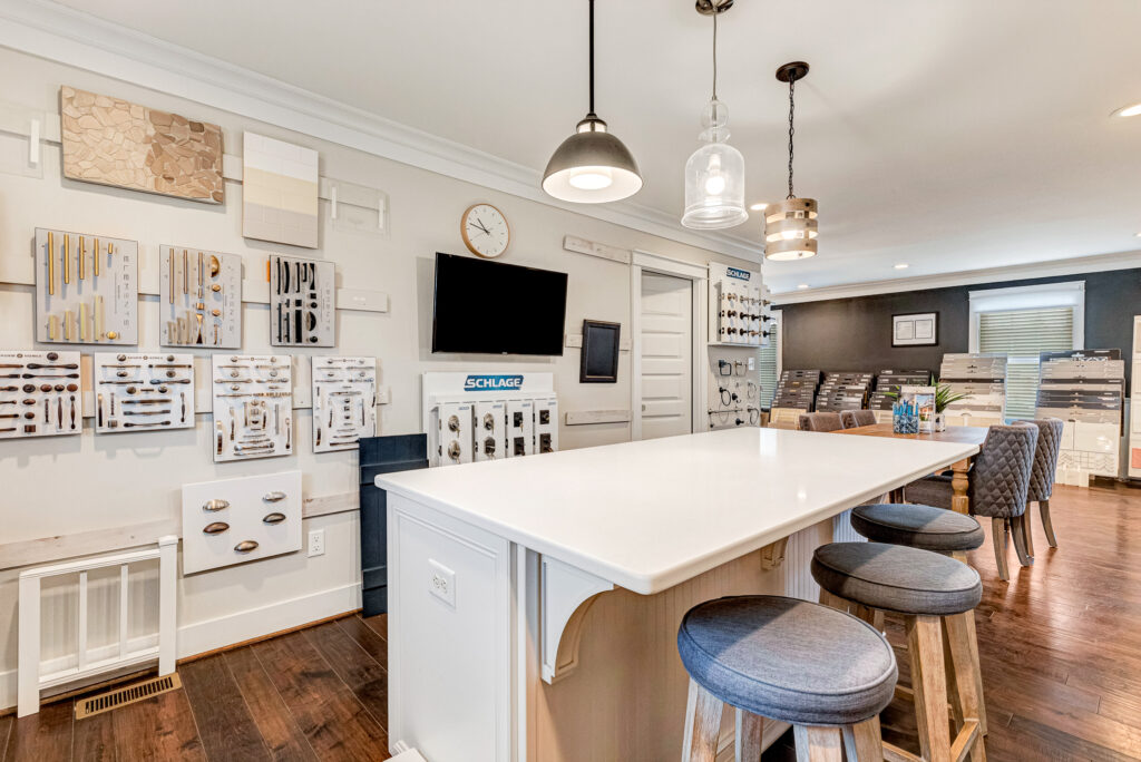 A Design Center with a long white counter, bar stools, and wall displays of cabinet handles and hardware.