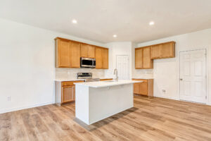 Modern kitchen in Poplar Village with wooden cabinets, center island, and stainless steel appliances.