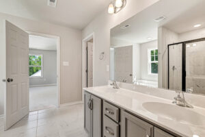 Bathroom in Somerset Hill with a double-sink vanity and a walk-in shower.