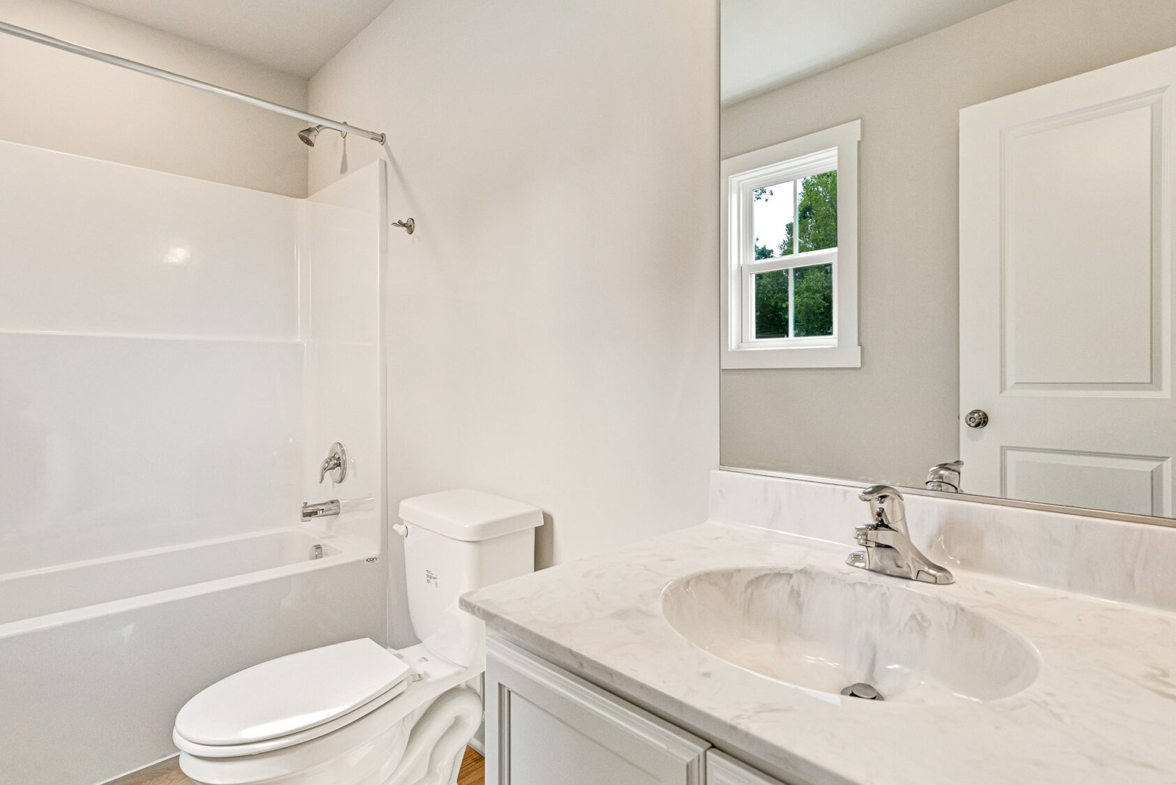 Bathroom at Somerset Hill with a white vanity, toilet, and a tub-shower combination.